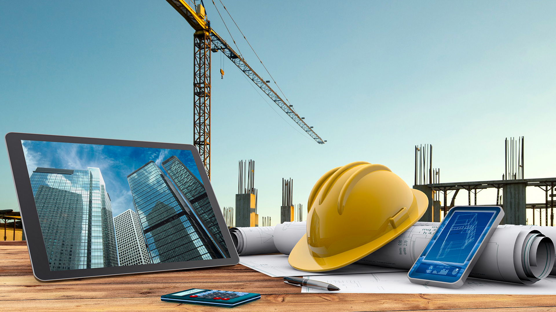 Construction planning table with crane, helmet and blueprint